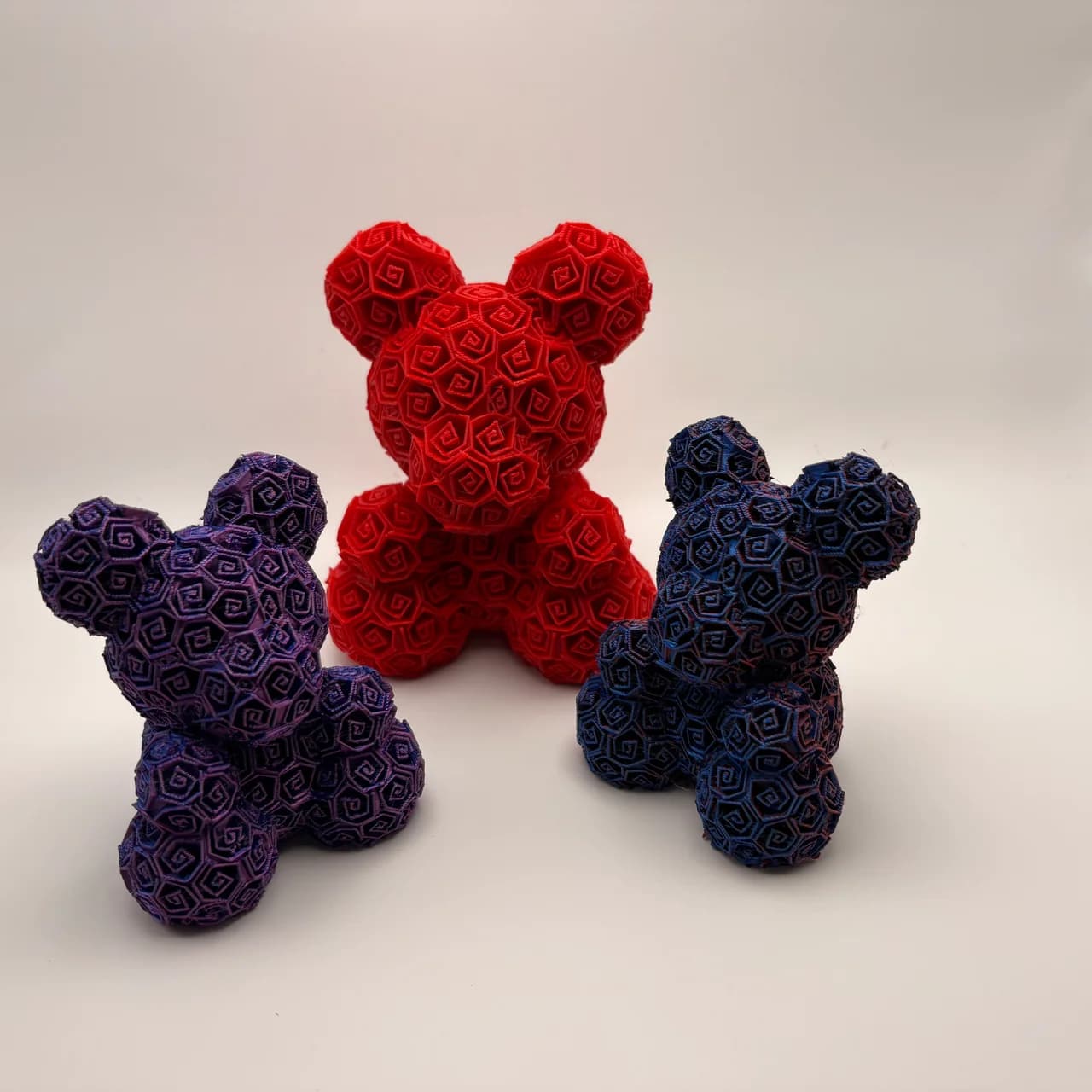 Three decorative bears formed from detailed rose patterns